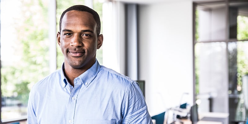 Man in office looking at camera