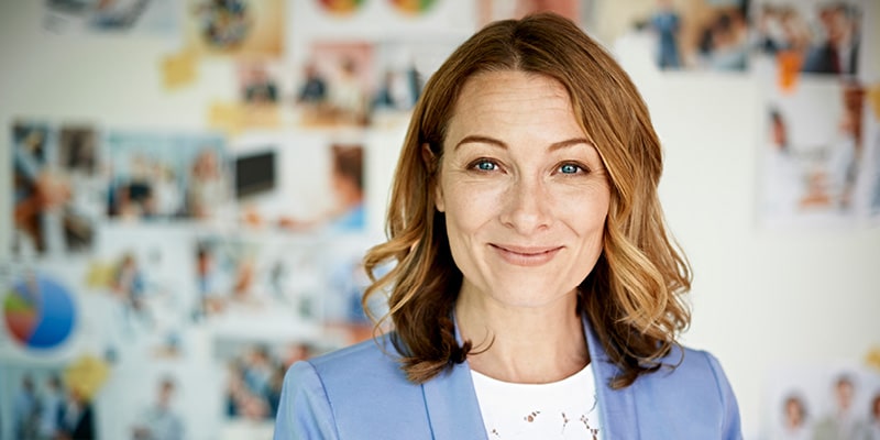 Woman used for Cyber Security online course in blue jacket smiling at the camera